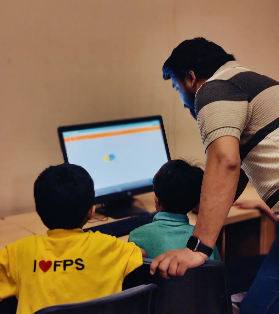 Students learning coding with mentor guidance